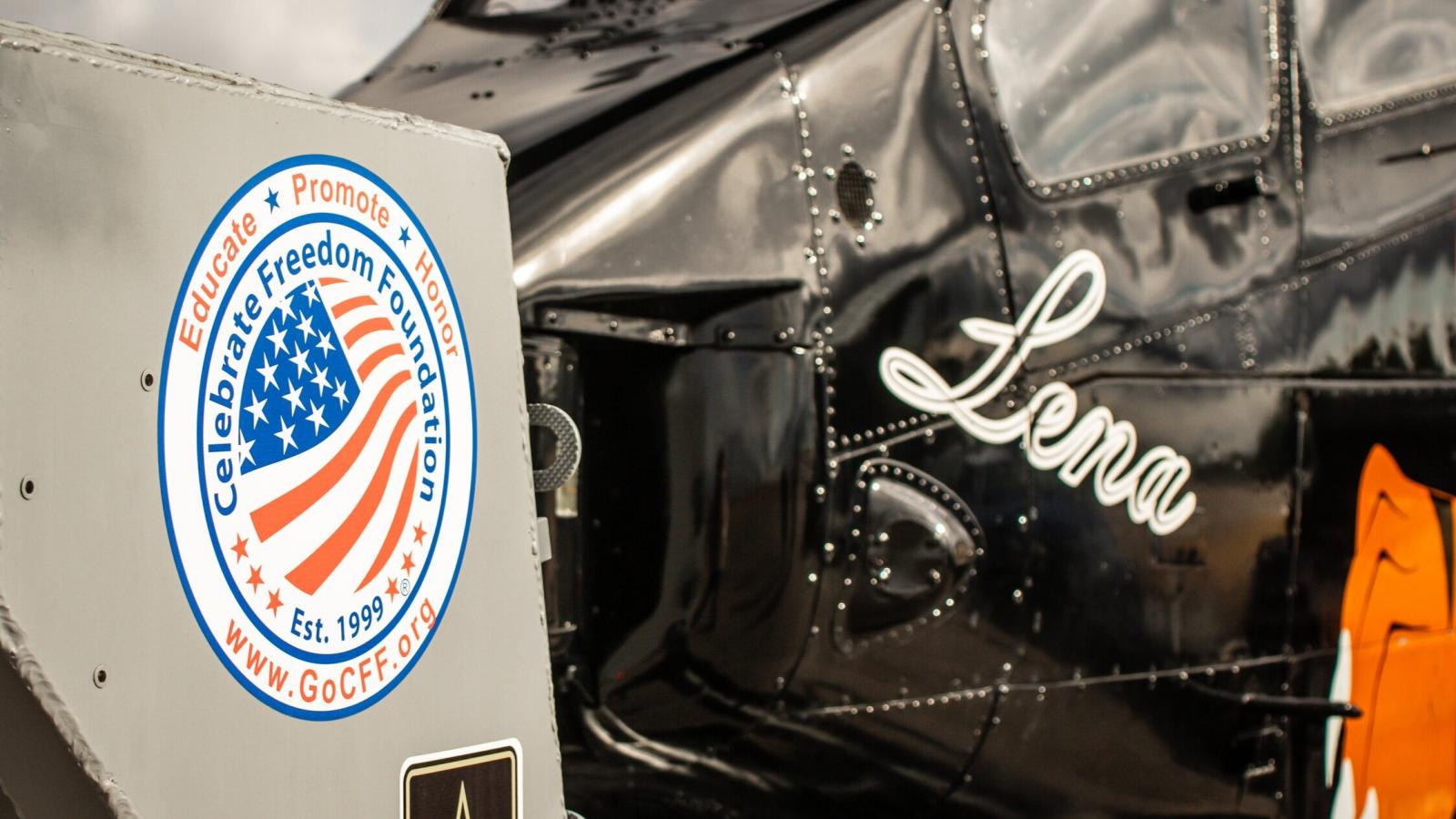 Vintage airplane with the name 'Lena' painted on the side